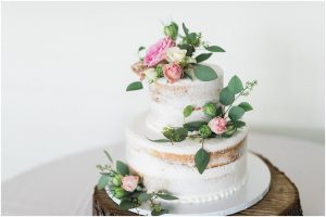 Naked wedding cake with florals and greenery